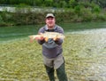 Fisherman holding a fresh caught fish Royalty Free Stock Photo