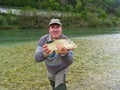 Fisherman holding a fresh caught fish Royalty Free Stock Photo