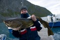 Fisherman holding huge fish Royalty Free Stock Photo