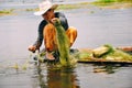 A fisherman holding a net at Inle Lake.