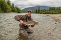 A fisherman holding a huge Taimen trout caught on a river in Mongolia, Moron, Mongolia