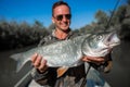 Fisherman holds the Asp fish Royalty Free Stock Photo