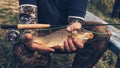 Fisherman holds a fish in his hand Royalty Free Stock Photo