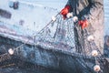 Fisherman holds a frozen fishing net in his hands