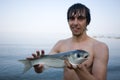 Fisherman holds a sea mullet Royalty Free Stock Photo