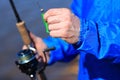 Fisherman holds spinning and bait close up. Fishing Royalty Free Stock Photo
