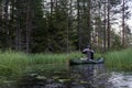 Fisherman on an inflatable boat photographs a beautiful morning landscape on a smartphone camera, against the background Royalty Free Stock Photo