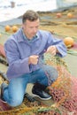 Fisherman inspecting nets Royalty Free Stock Photo