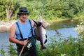 Fisherman keeps caught male pink salmon was caught in the river