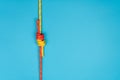 Fisherman knot with red and yellow climbing rope on blue background