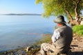 Fisherman by lake Royalty Free Stock Photo