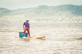 Fisherman of lake in action when fishing on twilight, Thailand. Royalty Free Stock Photo