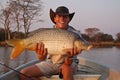 Fisherman with large carp Royalty Free Stock Photo