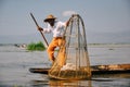 A fisherman with large net on Inle Lake.