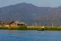 Fisherman with Leg rowing and Floating Village , inle lake in Myanmar (Burmar) Royalty Free Stock Photo