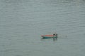 Fisherman on long tail boat on calm sea for fish hunting