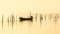 Fisherman on long tail boat in lake on sunrise at Pakpra village