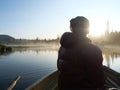 Fisherman man in rowing boat at lake Sjabatjakjaure in Beautiful sunny morning haze mist in Sweden Lapland nature. Mountains, Royalty Free Stock Photo