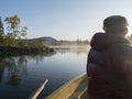 Fisherman man in rowing boat at lake Sjabatjakjaure in Beautiful sunny morning haze mist in Sweden Lapland nature Royalty Free Stock Photo