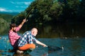 Fisherman men friends and trophy trout. Father and son fishing. Generations men fishing in river. Royalty Free Stock Photo