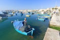 Fisherman mending a net in his fishing boat Royalty Free Stock Photo