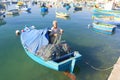 Fisherman mending a net in his fishing boat Royalty Free Stock Photo