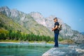 Fisherman on the mountain river at the nice summer day. Trout fly fishing in the mountain river with mountains in background Royalty Free Stock Photo