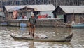 Fisherman with net in boat, Tonle Sap, Cambodia Royalty Free Stock Photo