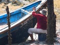 Fisherman painting fishing boat