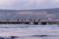 Fisherman on pier of Feodossia fishing on Black sea before sunrise Royalty Free Stock Photo