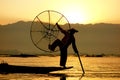 A fisherman poses at sunrise, Inle Lake, Myanmar