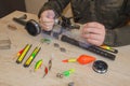 Fisherman prepare to fishing. Tools and accessories on wooden table Royalty Free Stock Photo