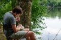 Fisherman preparing lure, fishing getaway vacation