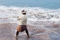 Fisherman pulls fishing net on Samudra beach in Kovalam