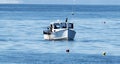 Fishing boat pulls lobster traps into boat Royalty Free Stock Photo