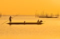 Fisherman punting his boat after fishing in sunset at Songkhla Lake, Songkhla, Souhtern of Thailand Royalty Free Stock Photo