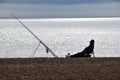 Fisherman relaxing on a beach at sunrise Royalty Free Stock Photo