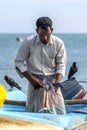 A fisherman removes fish from a net on Arugam Bay beach on the east coast of Sri Lanka.