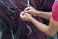 Fisherman repairing fishing nets