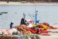 Fisherman, repairing his nets, in port of Sines, Portugal