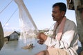 Fisherman repairing net