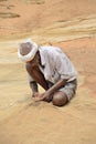 Fisherman repairs a fishing net