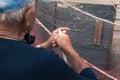 Fisherman repairs fishing net