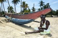 A fisherman repairs his nets on Arugam Bay beach on the east coast of Sri Lanka. Royalty Free Stock Photo