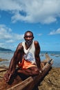 fisherman resting on his outrigger canoe at the stunning shore of the tropical south pacific ocean