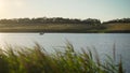 A man rides a motor boat in an inflatable boat on a lake at sunset. Fisherman rides a motor boat on the river Royalty Free Stock Photo