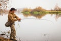 Fisherman on the river bank Royalty Free Stock Photo