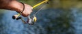 Fisherman on the river bank. Man fisherman catches a fish. Fisherman in his hand holding spinning. Fisherman hand Royalty Free Stock Photo