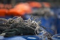 Fisherman rope on plastic barrels with orange life jackets in background Royalty Free Stock Photo