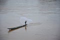 Fisherman hunts fish in the wide river